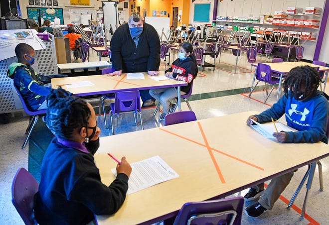 James Cross, Rocketship Nashville Northeast Elementary teacher, teaches reading to his students in Nashville, Tenn. Tuesday, Nov. 17, 2020.