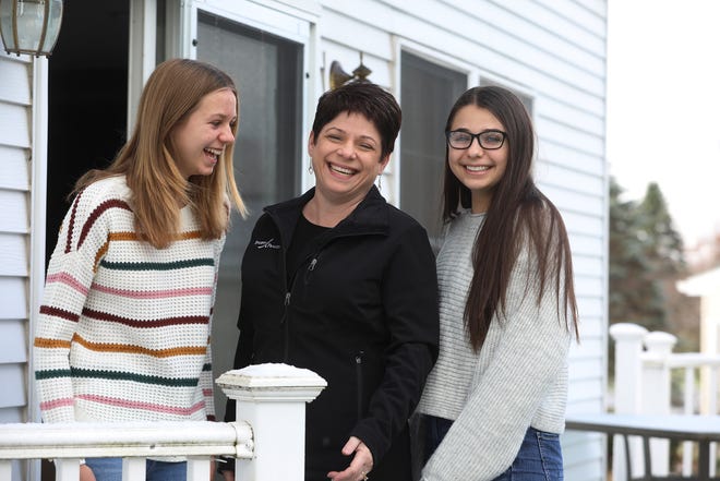 Kim Johnston, center, and her daughters, Katie, 14, at left, and Meghan, 16, are shown at their Fairport, New York, home on Nov. 17. This year they plan on doing their Black Friday shopping from the safety of their own home. Usually they are out of state for Thanksgiving and go on a shopping trip but with COVID-19 being a concern, their shopping will take place online.