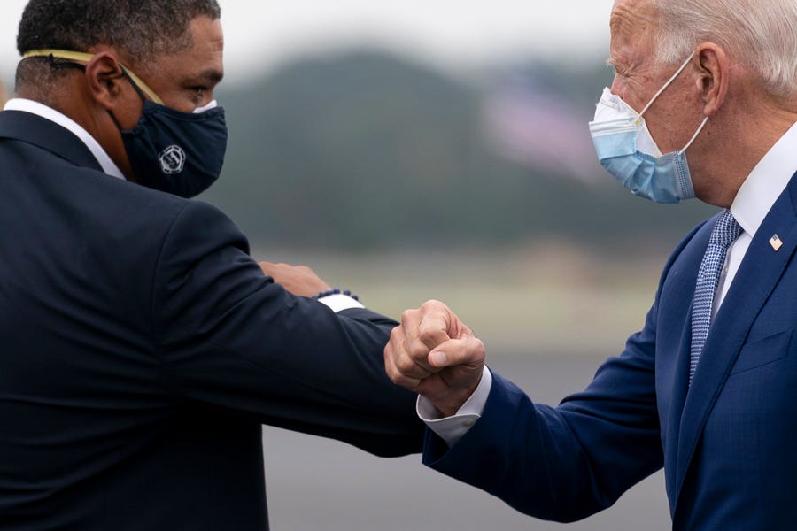 Democratic presidential candidate former Vice President Joe Biden greets Rep. Cedric Richmond, D-La., left, as he arrives at Columbus Airport in Columbus, Ga., on Oct. 27, 2020, to travel to Warm Springs, Ga. for a rally.