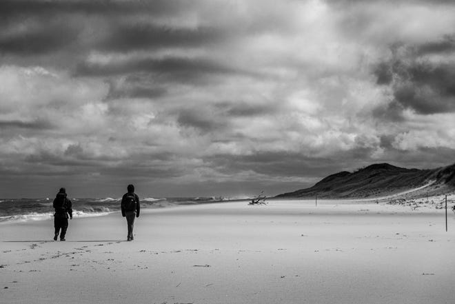 "In Nature's Wake": Nearly lifelong friends from Brewster walk along a deserted beach of the Cape Cod National Seashore as part of a 27-mile journey.