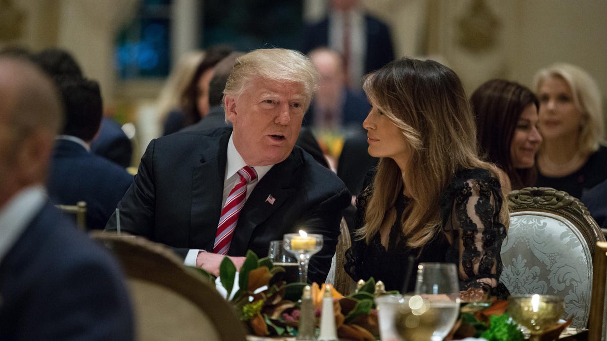 President Donald Trump, center, and first lady Melania Trump, sit with their family for Thanksgiving Day dinner at  Mar-a-Lago in Palm Beach on Nov. 22, 2018.