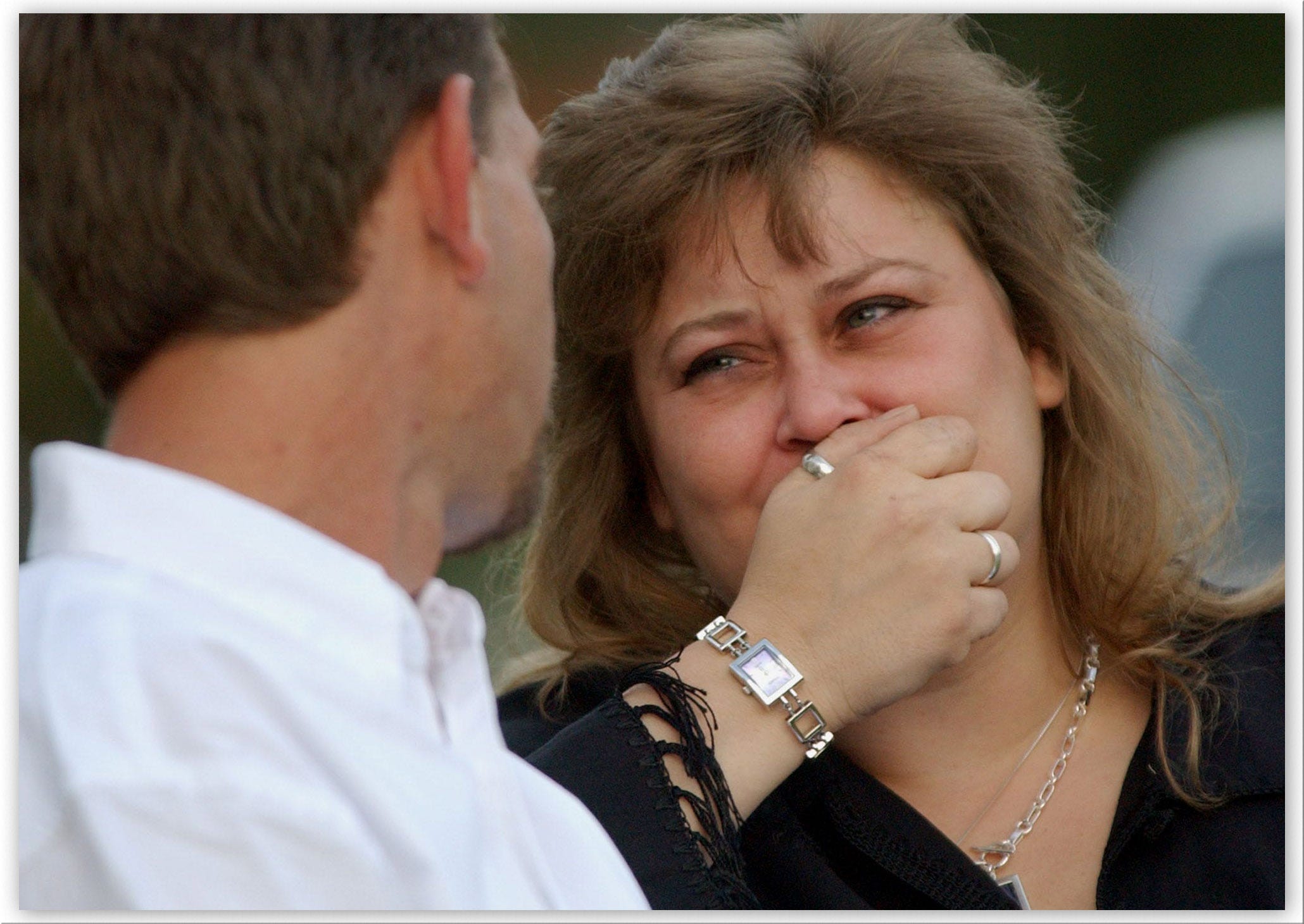 Susan Schorpen, right, mother of Carlie Brucia, cries as her husband Steve Kansler, Carlie's stepfather, comforts her during a memorial service for the 11-year-old Feb. 10, 2004 outside the Central Church of Christ in Sarasota, Fla.  Carlie's body was found behind the church.