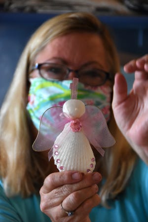 Jackie Lynch shows off a handcrafted shell angel. The Marco Island Shell Club will hold their annual pre-Christmas sale on Friday, Nov. 27, and Friday, Dec. 4, outdoors at St. Mark's Episcopal Church.
