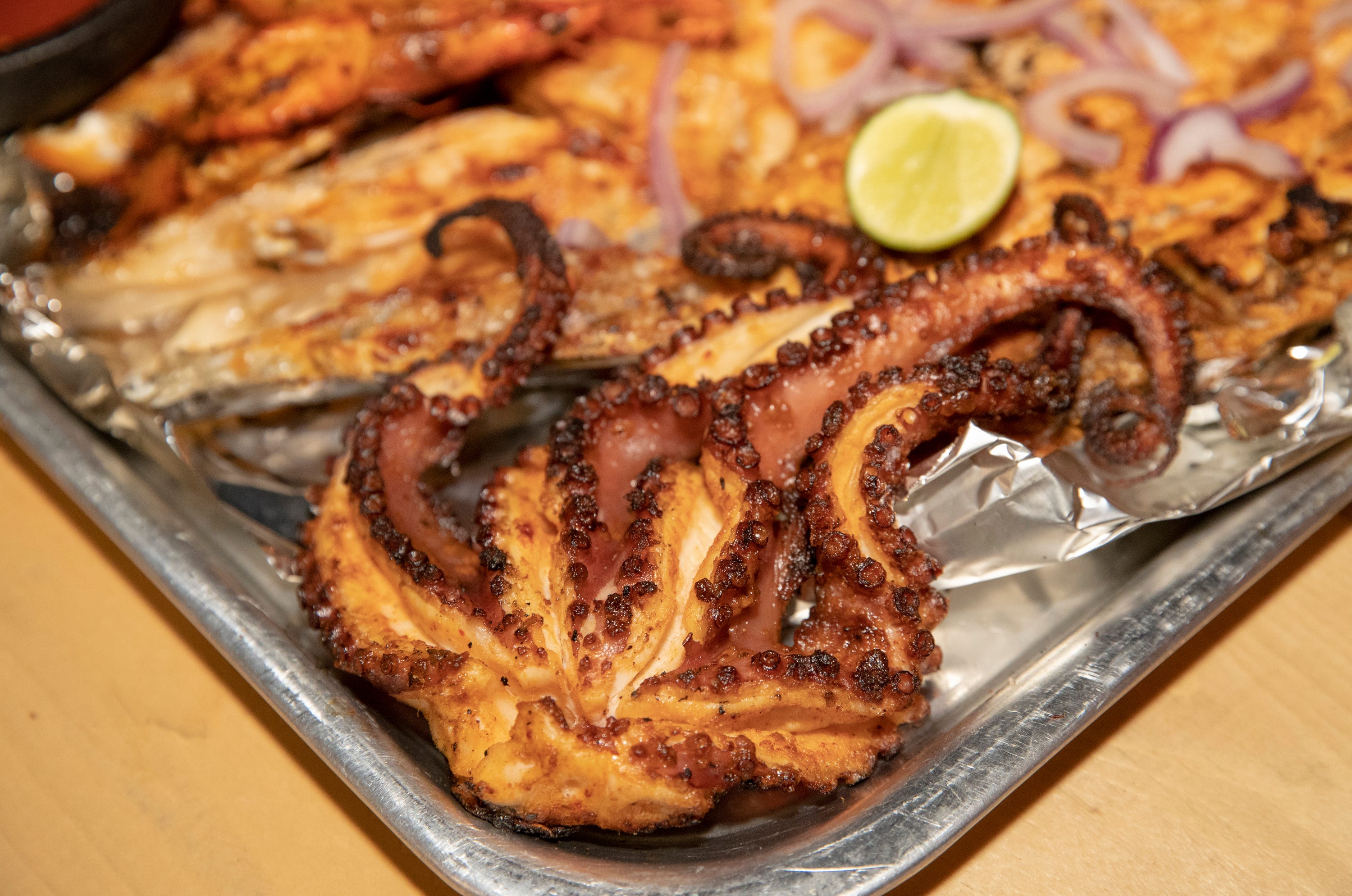 Mariscos del Valle owner Jesus "Chuy" Ruiz Navarro sells grilled octopus from his home business in Coachella, Calif., on Friday, November 13, 2020.