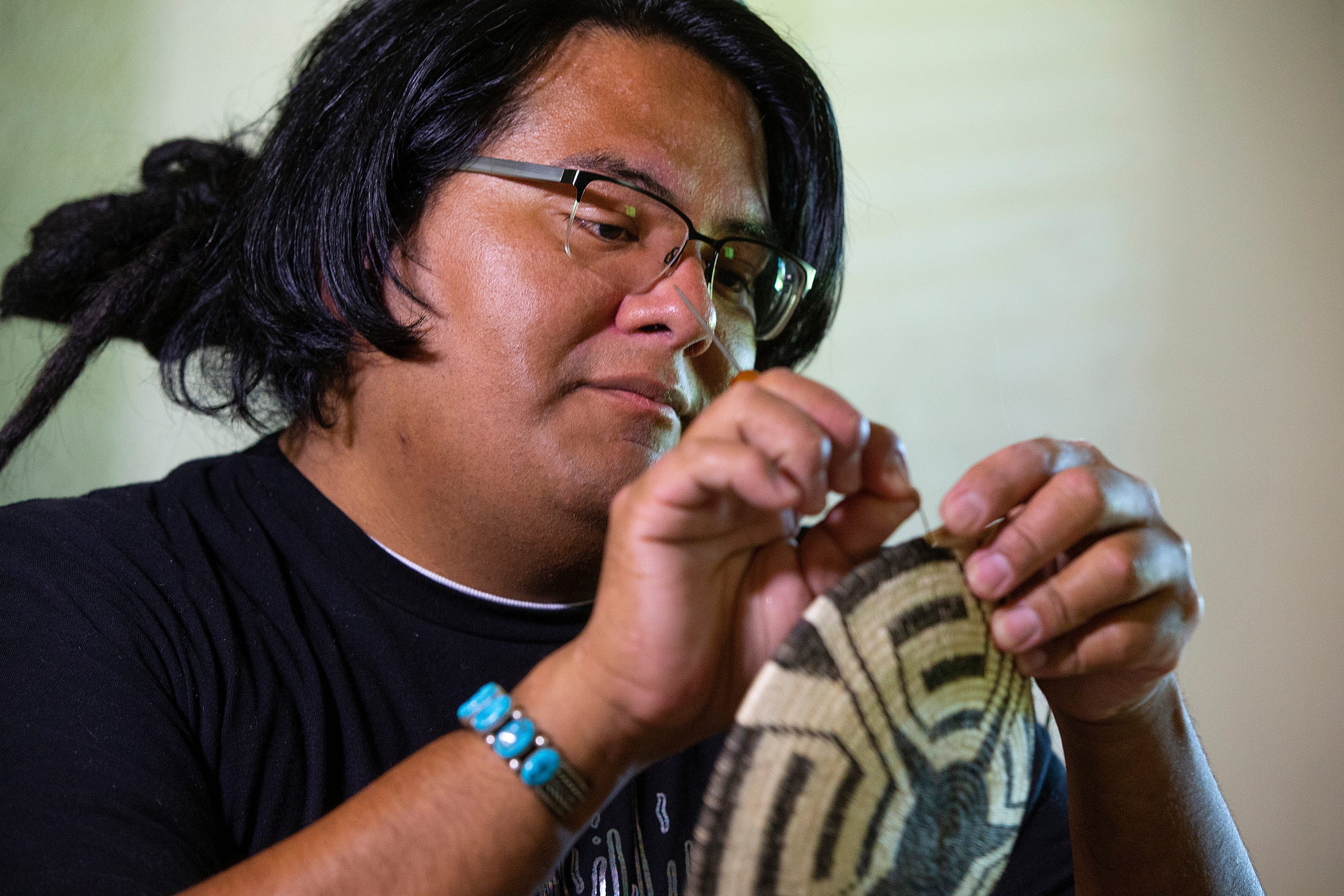 August Wood was born and raised in the Salt River Pima-Maricopa Indian Community, and he is one of the few basket weavers there. Wood uses natural materials to create his baskets. He finds cattails and willow along the river and he grows his own devils claw.