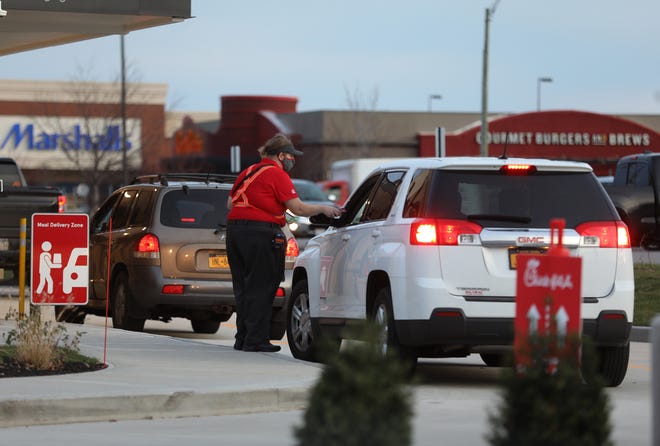 Chick-fil-A opened on Marketplace Drive November 19, 2020 in Henrietta.  Several cars went through the drive in around 7 a.m.  Employees come out to deliver orders and take payments on a mobile device.