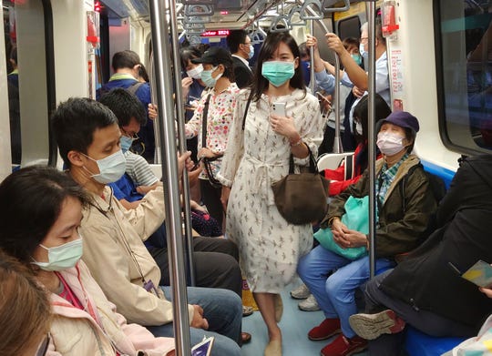 Passengers on the public metro in Taipei, Taiwan, wear face masks to help curb the spread of the coronavirus on  Nov. 16, 2020.