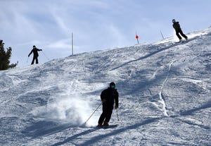 Skiers make their way down off the top of the hill during opening day at Mt. Rose Ski Tahoe near Reno in November 2020.
