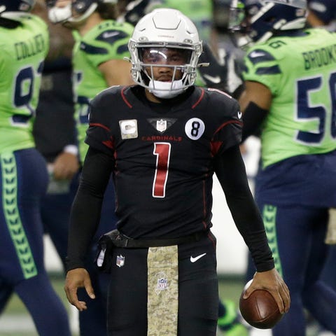 Kyler Murray walks on the field after being sacked