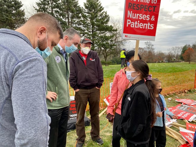 Congressman Brian Fitzpatrick, second from left,  chats with those gathered at the picket line at St. Mary Medical Center in Middletown on Saturday.