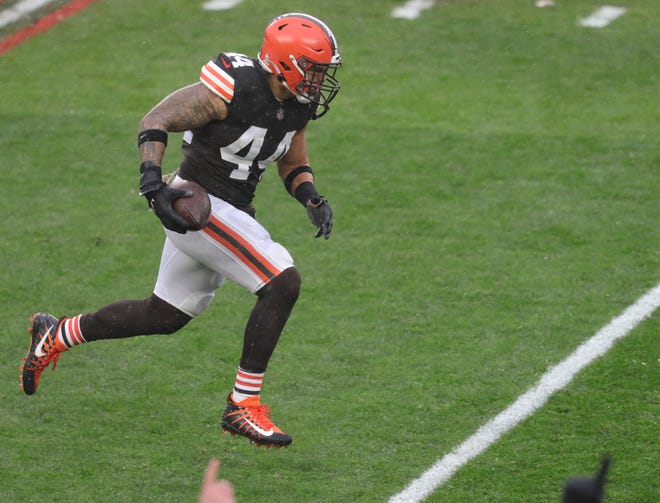 Browns linebacker Sione Takitaki runs back a first half interception against the Philadelphia Eagles on Sunday in Cleveland.