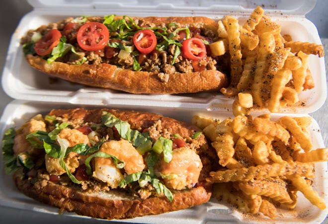A Zheesesteak with Zries, top, and a Zteak and Zhrimp with Zries are displayed in the Zoagies food truck. The food truck is located in New Castle.