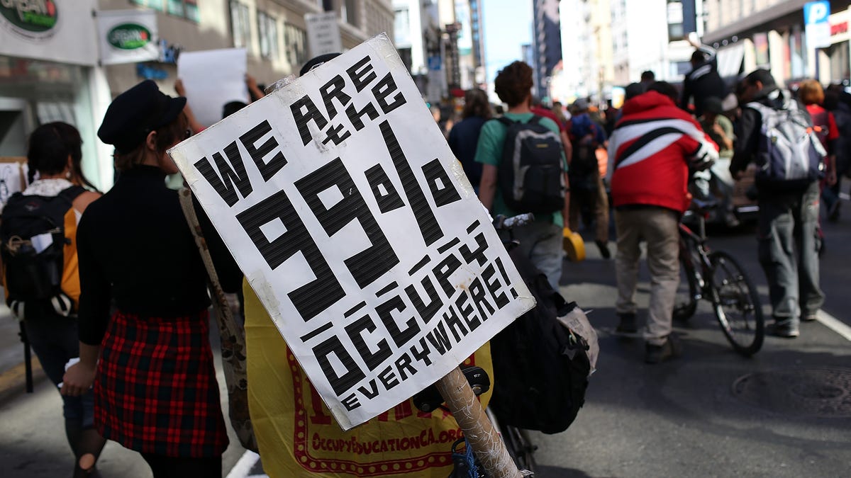 An Occupy Wall Street protester holds a sign during a demonstration on September 17, 2012 in San Francisco, California.