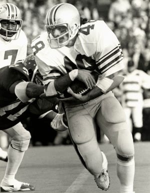 Former Ohio State wingback Brian Baschnagel, here running in a win at Michigan in 1975, has gotten no answers why he has been dealing with dizziness and a loss of balance in recent years.