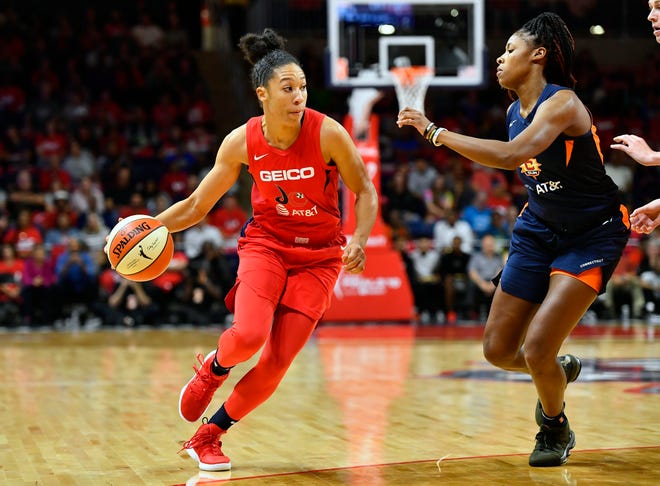 Washington Mystics forward Aerial Powers dribbles as Connecticut Sun guard Bria Holmes defends during game two of the 2019 WNBA Finals at The Entertainment and Sports Arena on Oct. 1, 2019.