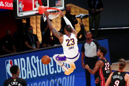 Los Angeles Lakers forward LeBron James dunks against the Miami Heat during the fourth quarter during the NBA Finals, which were spent in a Florida bubble.