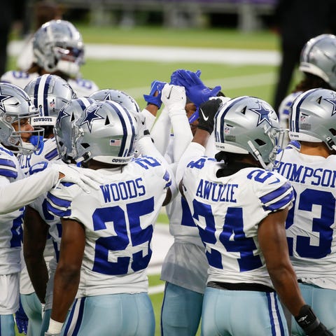 Dallas Cowboys players huddle on the field before 