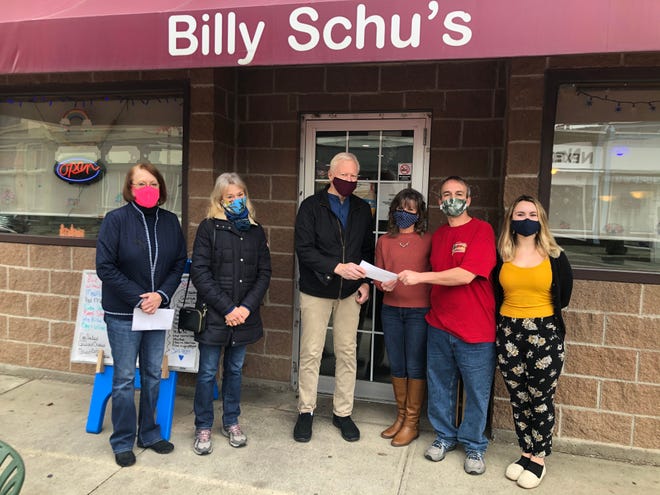Bethesda Foundation reps pass on a $1,000 check on Tuesday to Billy Schu's to support the restaurant's free Thanksgiving meals tradition. From left, Janice Spence, Bethesda Foundation executive director; Lynn Blades, president of the foundation board; Jay Pullman, vice president of the Bethesda Foundation board; and Lori, Ian and Victoria Cramp of Billy Schu's.