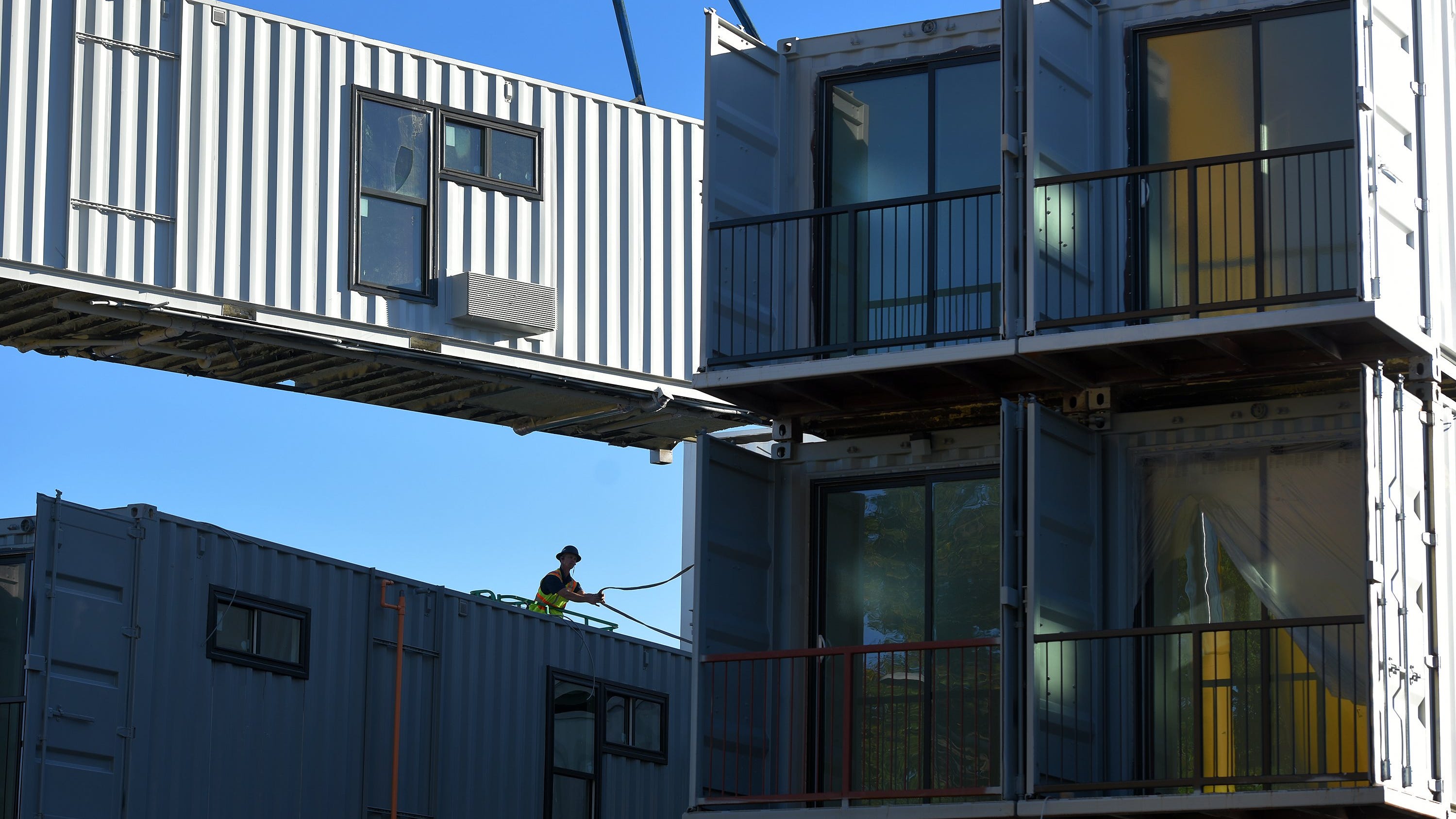 The shipping containers stacked to make an 18-unit residential development on Ashley Street in downtown Jacksonville have balconies and windows added to them as part of their conversion to studio apartments and Airbnb rentals. The work is on track to finish by the end of the year so the unusual twist to housing will be available for rent in 2021.