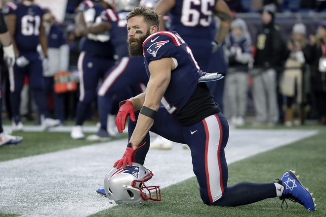 Published Caption:  Patriots wide receiver Julian Edelman displays the Star of David on his shoes as part of the “My Cause My Cleats” campaign as he warms up before the game against the Kansas City Chiefs Dec. 8 in Foxboro.