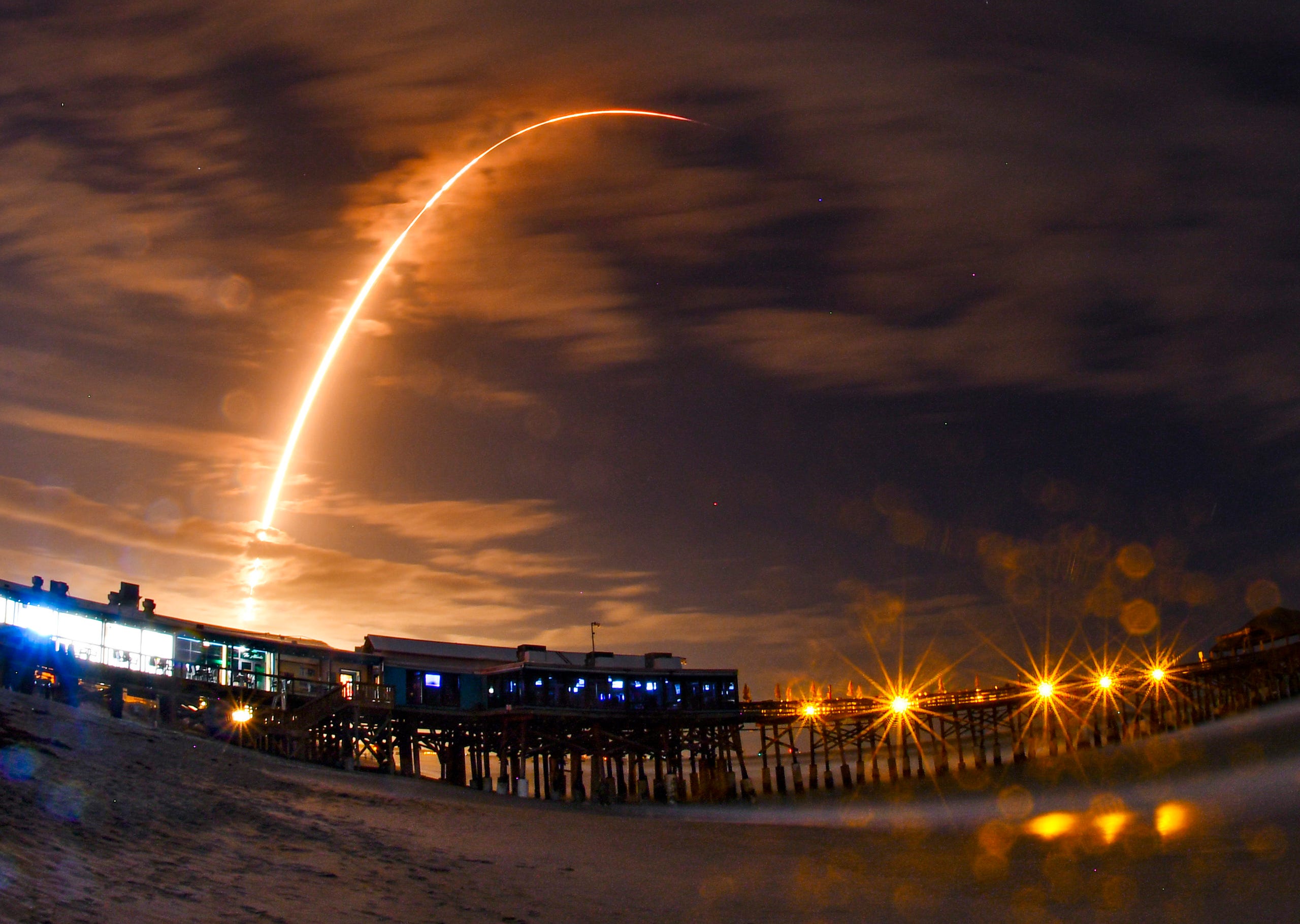 A SpaceX Falcon 9 rocket is seen from the Cocoa Beach Pier as it launches the company's 16th Starlink mission from Cape Canaveral on Tuesday, Nov. 24, 2020.
