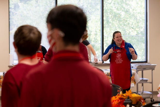 Salvation Army Social Services Coordinator Julie Smith gives volunteers a few words of encouragement before people start filing in for the organization's annual Thanksgiving meal Wednesday, Nov. 25, 2020. 