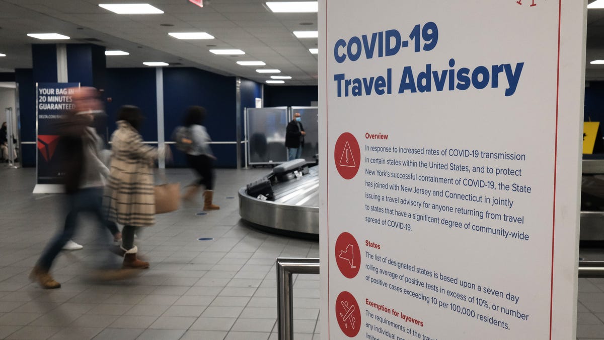 Signs warn travelers of Covid-19 in New York's LaGuardia Airport. Despite warnings from the government and politicians not to travel for the Thanksgiving holiday due to the Covid-19 pandemic, millions of Americans have been flying and driving to meet friends and family for the holiday.