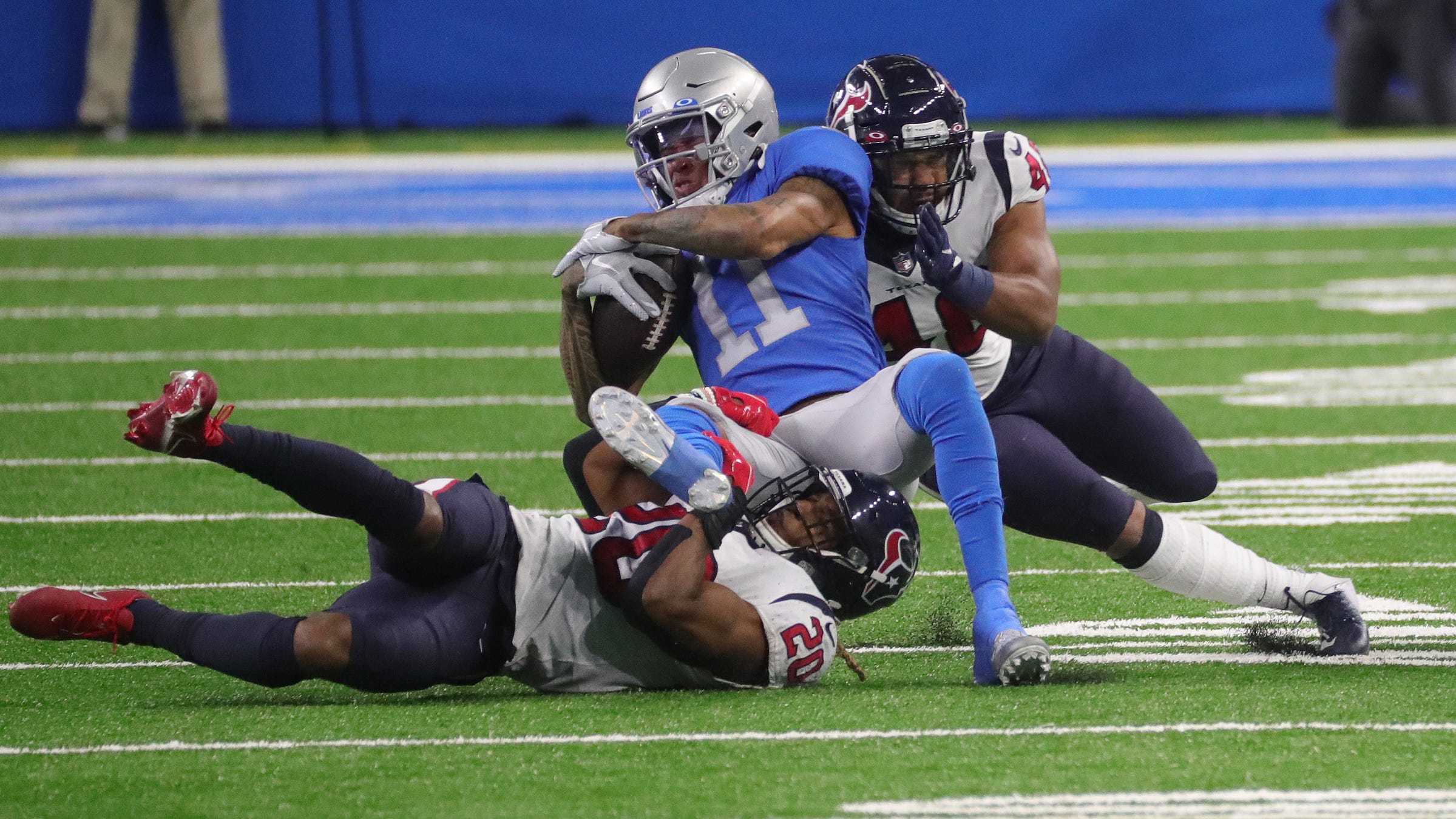 Lions wide receiver Marvin Jones makes a catch against Texans strong safety Justin Reid, left, and linebacker Nate Hall during the second half of the Lions' 41-25 loss at Ford Field Thursday, Nov. 26, 2020.