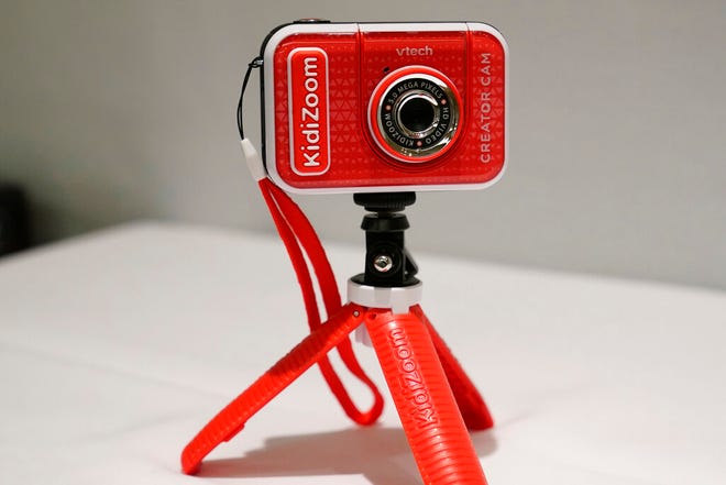 A KidiZoom Creator Cam by VTech is displayed at the Toy Fair, Thursday, Sept. 17, 2020, in New York. The digital camera comes with a green screen and animated backgrounds allowing kids to go to outer space, get chased by T-Rex, or make things disappear. The camera comes with a tabletop tripod, which can also be used as a selfie stick. (AP Photo/Kathy Willens)