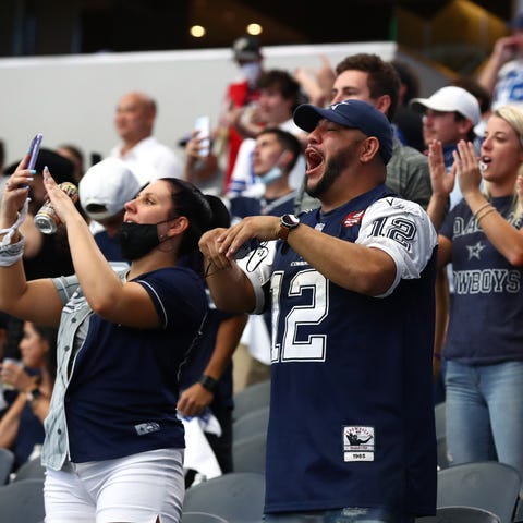 Cowboys fans cheer during the team's win against t
