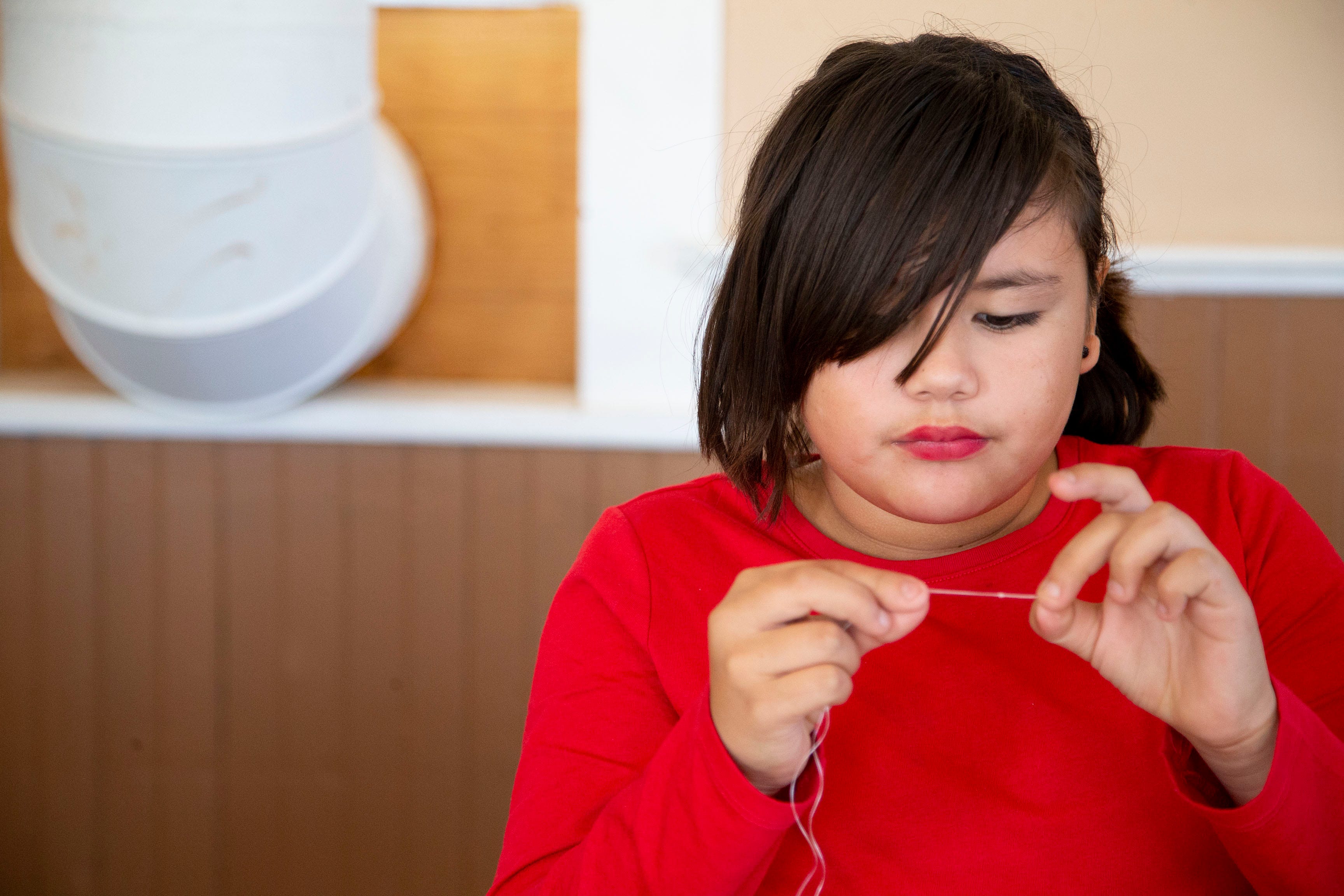 Annabell Tortes, 10, makes jewelry in Parker on Nov. 23, 2020.