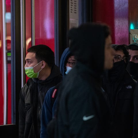 A man wearing a protective mask looks inside a sto