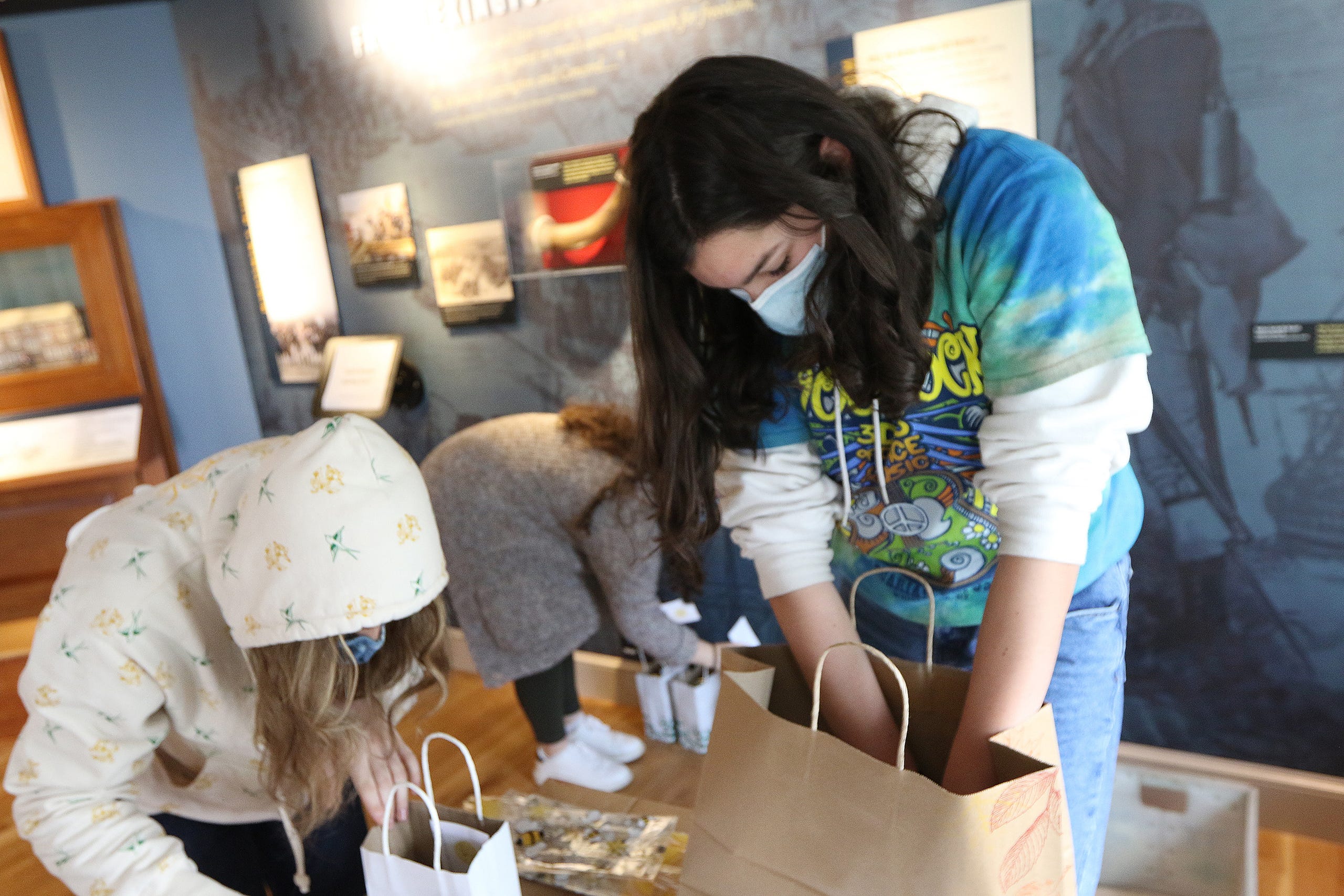 Freshman Lauren Jolley, 14, and other members of the Lexington High School Beekeepers Association, known also as the "Bee Club", filled advance orders at the Lexington Visitors Center. They were volunteering with the Lexington Bee Company on Small Business Saturday in Lexington, Nov. 28.