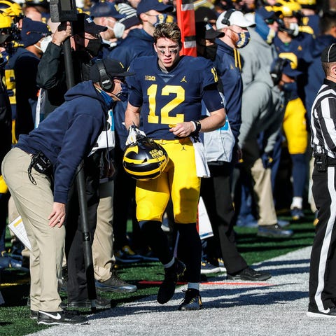 Michigan quarterback Cade McNamara talks to coach 