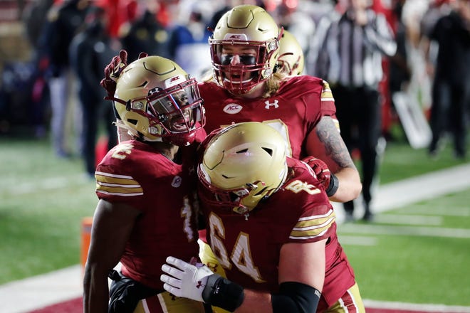 Boston College wide receiver CJ Lewis (left) celebrates his touchdown during the second half of the Eagles 34-27 win over Louisville on Saturday, Nov. 28 in Boston. (AP Photo/Michael Dwyer)