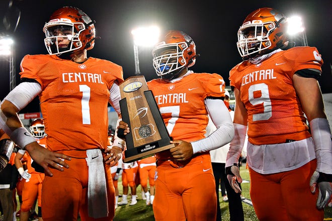 From left, Central York's Beau Pribula, Seth Griffiths and Jack Smith hold the team's runner-up trophy after falling 62-13 to St. Joseph's Prep in the PIAA Class 6-A football championship game at Hersheypark Stadium in Hershey on Saturday, Nov. 28. The PIAA wants to be exempt from the state's Right-to-Know Law. Dawn J. Sagert photo