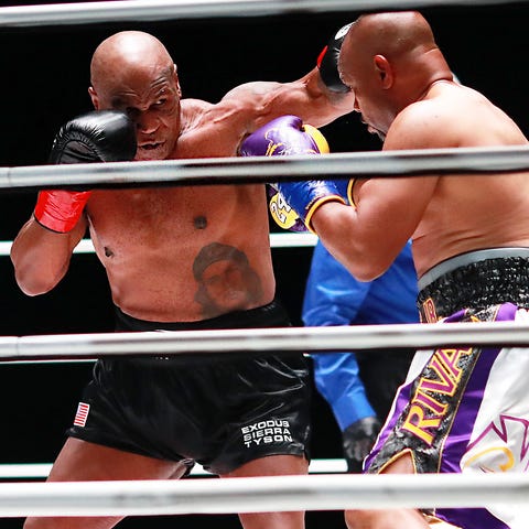 Mike Tyson throws a punch against Roy Jones Jr. du