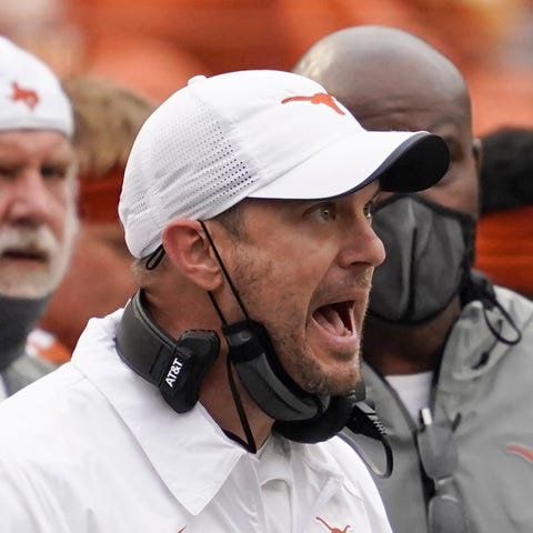 Texas coach Tom Herman argues a call with field ju