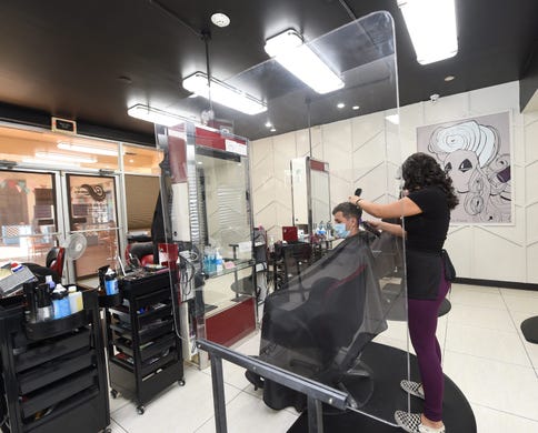 Large shields separate hair styling stations during the COVID-19 pandemic at Salon Fusion by Loren, Agana Shopping Center.