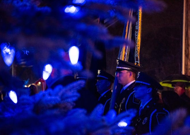 File- Members of the Lower Southampton Police honor guard stand at attention during the 19th Annual Project Blue Light Holiday Tree Lighting in 2019 , paying tribute to fallen police officers.