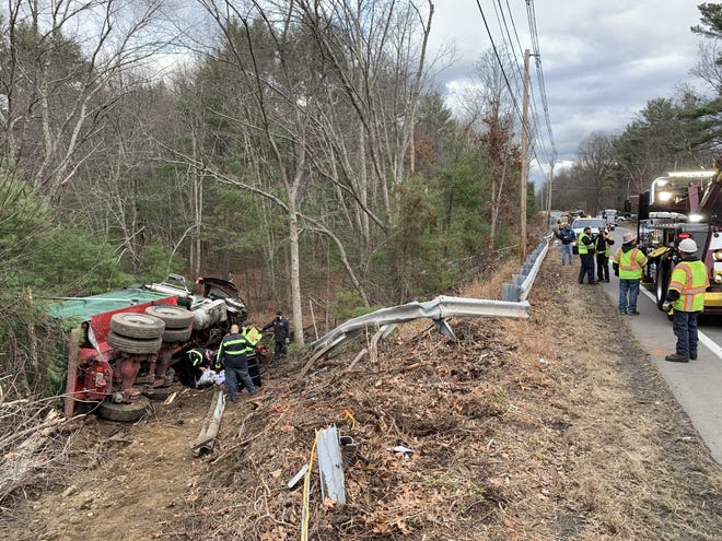 The dump truck went off the road and down an embankment after the head-on collision on Route 16 in Uxbridge.