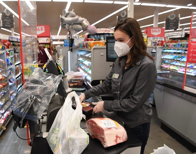 A cashier works at Stop & Shop.
