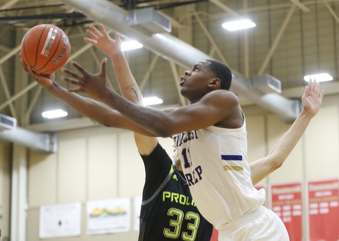 Hillcrest Prep's Michael Foster (11) drives the lane against Prolific Prep's Coleman Hawkins (33) during the 2019 Hoophall West basketball tournament at Chaparral High School in Scottsdale, Ariz. on Dec. 5, 2019.