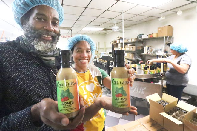 Omar Brown and Camille Holder-Brown, owners of Kale Cafe Juice Bar & Vegan Cuisine, hold the first two bottles of their Judah's salad dressing and marinade, at Stage Coach Sauces in Daytona Beach, Wednesday, Nov. 18, 2020.