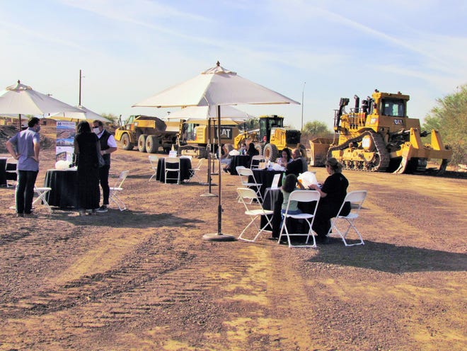 Merit Partners representatives and community members meet at the site of a future industrial park in south Phoenix. The Phoenix-based developer is doing an $11 million environmental cleanup to get the property ready for building.