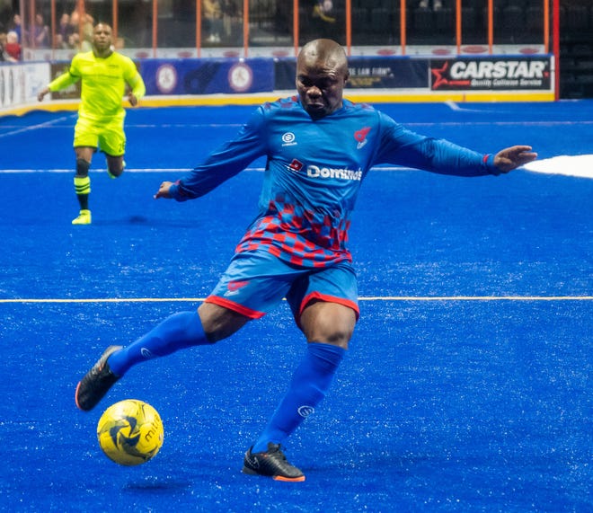 With Milwaukee's Ian Bennett, left, trailing, Comets player/coach Leo Gibson takes a shot on goal in an MASL playoff game against the Wave in 2019. Gibson, as the player coach, will be teammates with Bennett on the East squad as the Comets host the MASL All-Star game Saturday at Cable Dahmer Arena in Independence.