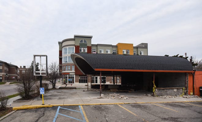Biggby Coffee's original location on Grand River Avenue in East Lansing seen under demolition, Friday, Dec. 4, 2020.  The building, built in 1966, once housed an Arby's and has a curved roof intended to resemble a covered wagon.
