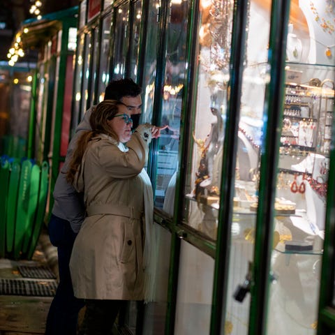 Costumers look through the window of a seasonal st