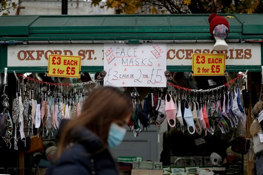 Face masks to curb the spread of coronavirus are displayed for sale as non-essential shops are allowed to reopen after England's second lockdown ended at midnight, on Oxford Street, in London, Dec. 2, 2020.