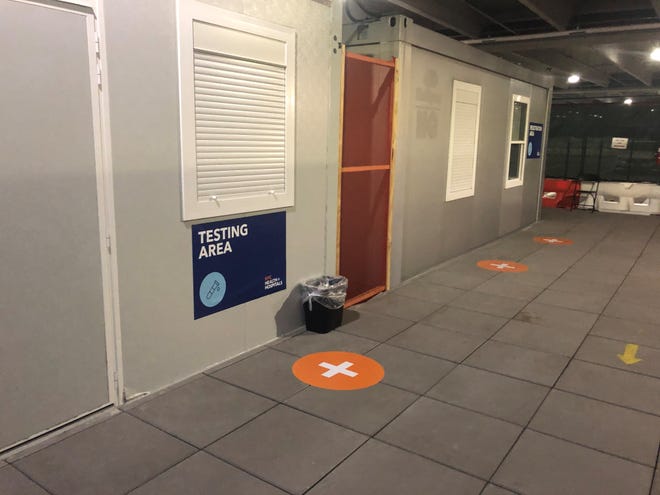 LaGuardia Airport in New York offers free COVID-19 testing in modular offices in a parking garage in Terminal B. Travelers visit three windows, with the test conducted at the last one.